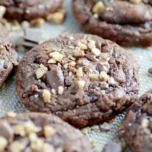 Deep, dark chocolate brownie cookies loaded with chocolate chunks and milk chocolate toffee bits. Crackly tops, fudgy centers, and chewy edges.