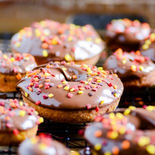 Perfectly baked pumpkin donuts coated with cinnamon sugar and topped with Nutella.
