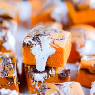 Pumpkin, Nutella, and marshmallow cream make this like no other pumpkin fudge you've had before!