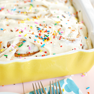 If you love licking the bowl, you'll be in heaven with this recipe for cake batter cinnamon rolls that are fluffy, soft, full of cinnamon, and topped with a dreamy cake batter cream cheese icing.