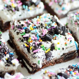 Super rich and fudgy brownies stuffed with Oreos and smothered in vanilla buttercream.