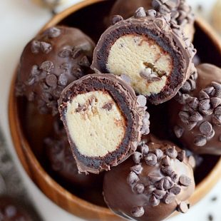 Cookie dough wrapped in a brownie and covered in chocolate. These Cookie Dough Brownie Bombs are even better than they look!