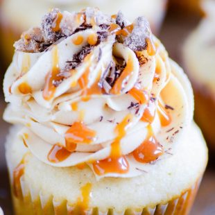 Vanilla cupcakes studded with chocolate chips and topped with peanut butter frosting, chocolate shavings, toffee, and butterscotch caramel. A cupcake worthy of the name TGIF!